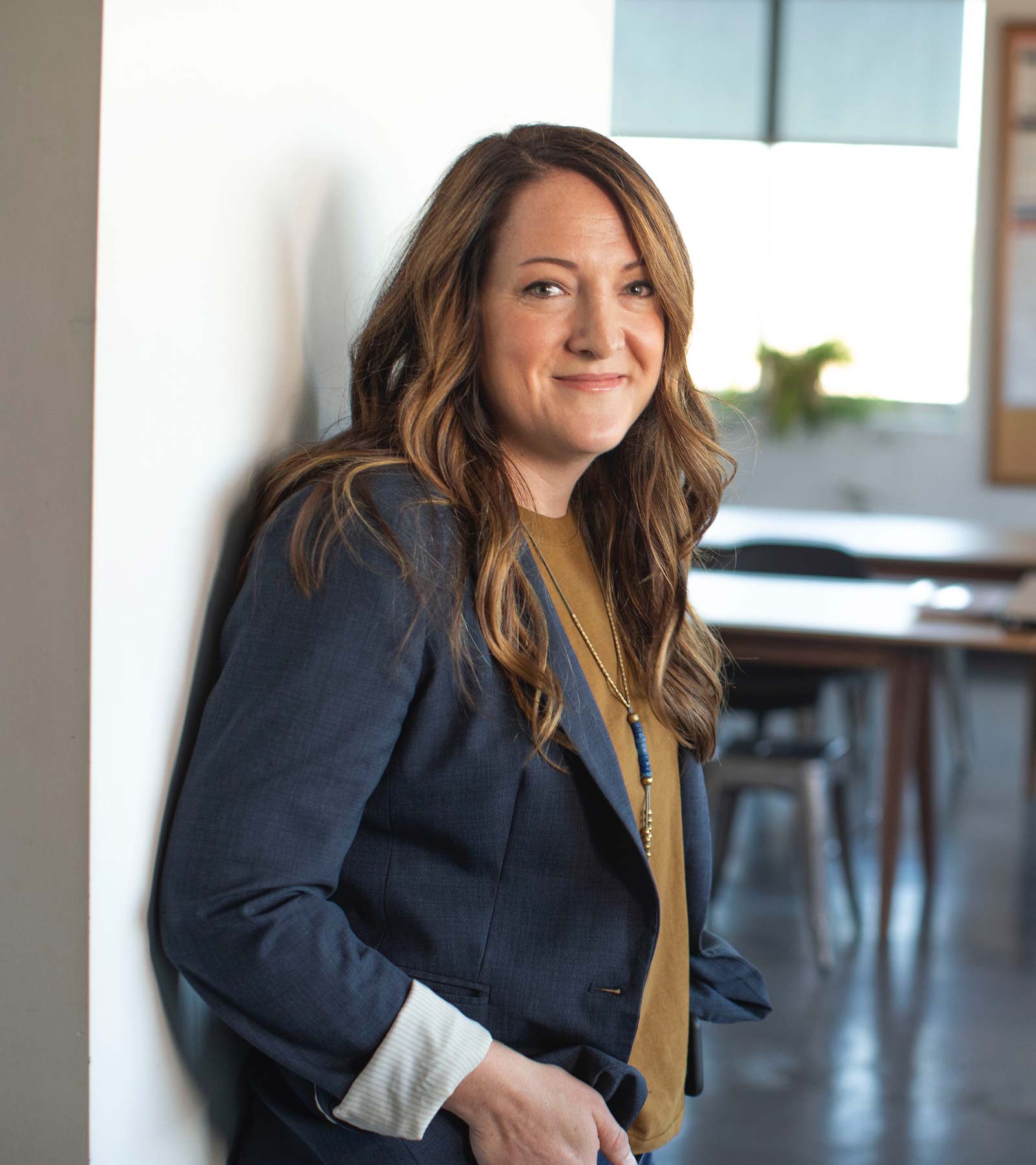 Woman Standing against Wall Smiling